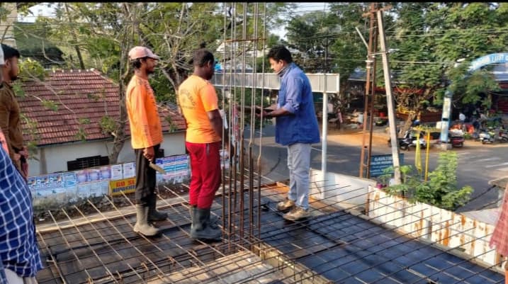 Architects reviewing construction drawings on site